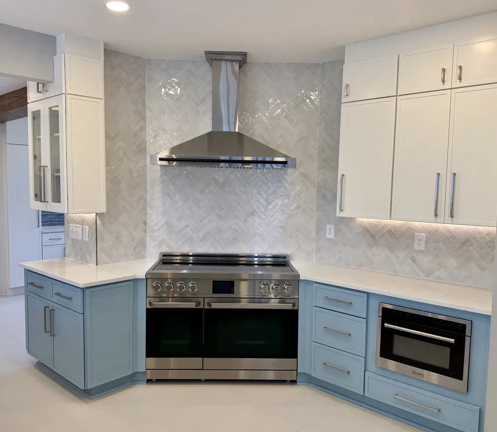 Full view of a bright, airy kitchen remodel with light blue cabinets and clean finishes.